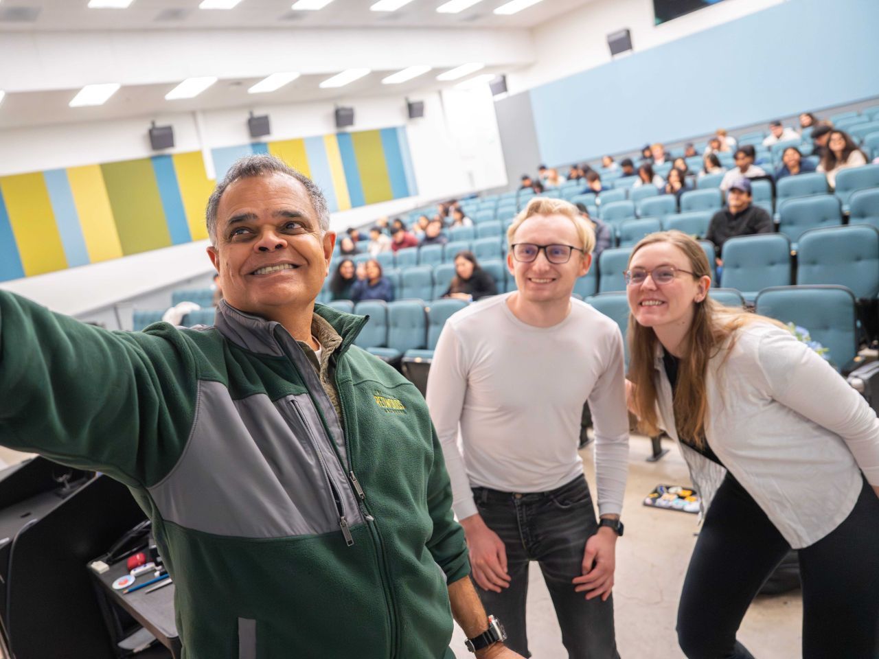 Shomit Ghose taking a selfie with Eric Berndt in front of the Amazoogle class