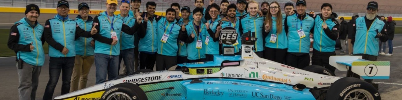 The AI Racing Tech team with their autonomous race car at the Indy Autonomous Challenge at CES